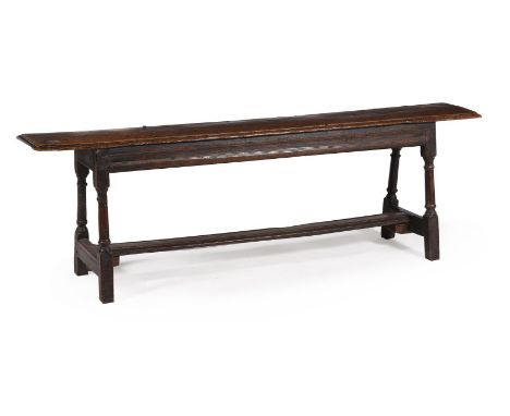 AN OAK BENCH OR LONG STOOL FIRST HALF 17TH CENTURY 60cm high, 187cm wide, 29cm deep 