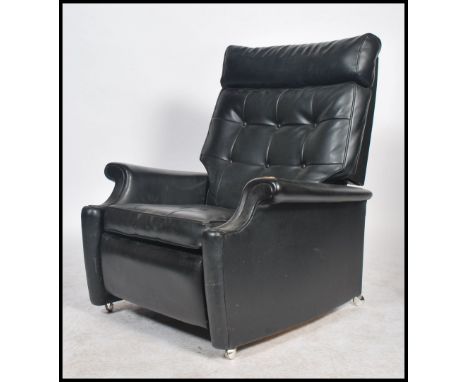 A retro 20th century 1960's black Parker Knoll recliner armchair. Button back seat and back rests, scroll arms and manual rec