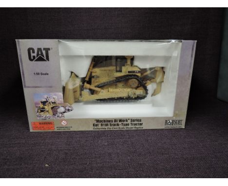 A Norscot 1:50 scale diecast, CAT Machine at Work Series D11R Track Type Tractor in yellow, in polystyrene packaging and in w