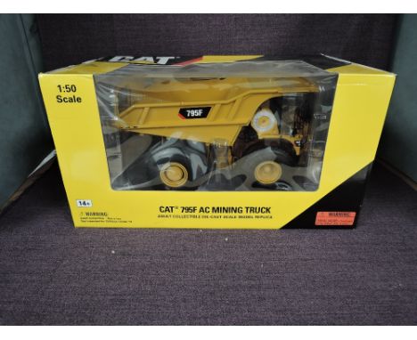 A Norscot 1:50 scale diecast, Cat 795F AC Mining Truck, in original window display box 55515