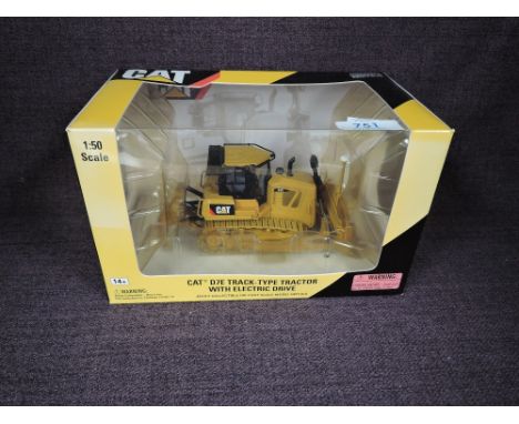 A Norscot 1:50 scale diecast, CAT D7E Track Type Tractor with Electric Drive in yellow, in plastic packaging and in window di