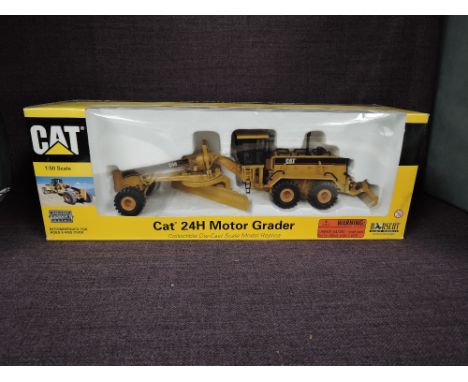 A Norscot 1:50 scale diecast, CAT 24H Motor Grader in yellow, in polystyrene packaging and in window display box 55133