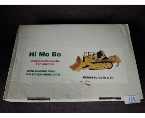 A Hi Mo Bo 1:50 scale white metal model, Komatsu D575 A SR in yellow, in polystyrene packaging and in card box