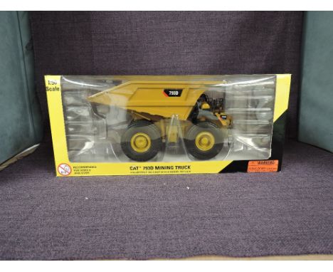 A Norscot 1:50 scale diecast, Cat 793D Mining Truck, in original window box 55174