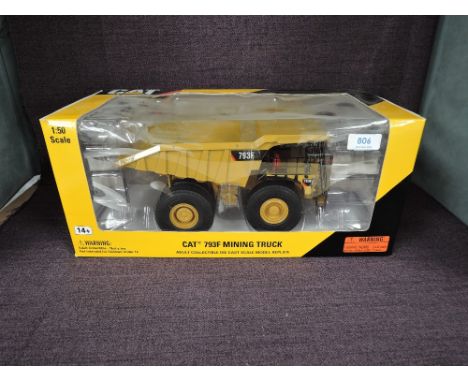 A Norscot 1:50 scale diecast, CAT 793F Mining Truck in yellow, in plastic packaging and in window display box 55273