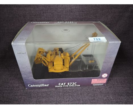 A Norscot 1:50 scale diecast, CAT 572E Track Type Pipelayer in yellow, in plastic packaging and in window display box 55210