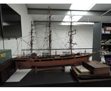 A wooden hand made scale model, Cutty Sark, with rigging on wooden stand