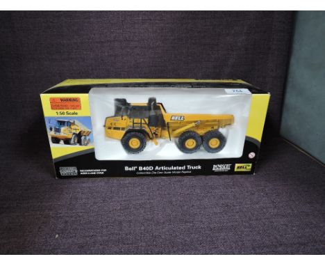 A Norscot 1:50 scale diecast, Bell B40D Articulated Truck in yellow, in polystyrene packaging and in window display box 57502