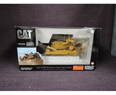 A Norscot 1:50 scale diecast, CAT D11R Carrydozer Track Type Tractor in yellow, in polystyrene packaging and in window displa