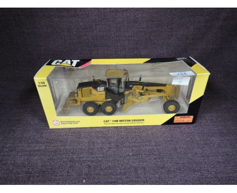 A Norscot 1:50 scale diecast, CAT 14M Motor Grader in yellow, in plastic packaging and in window display box 55189