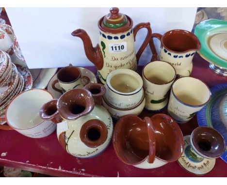 A quantity of Torquay Pottery motto ware including Watcombe coffee pot, Longpark chamberstick, etc.
