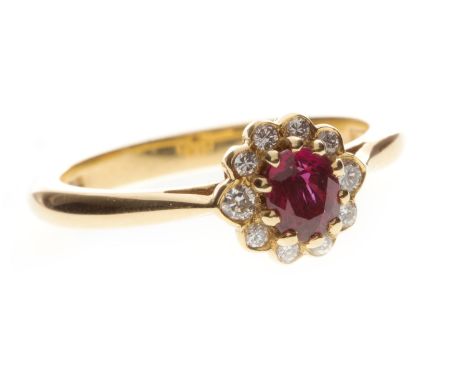 RUBY AND DIAMOND CLUSTER RING, the central oval ruby surrounded by round brilliant cut diamonds totalling approximately 0.22 