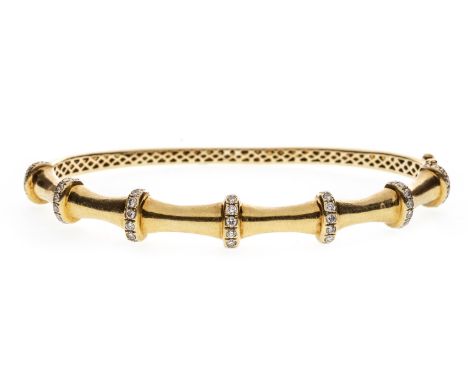 DIAMOND SET BAMBOO EFFECT BANGLE, of oval form, with diamond set bars interspaced by tapered blank sections, marked 750, 16g