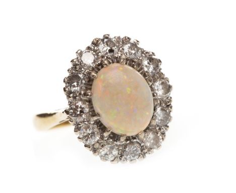 OPAL AND DIAMOND RING, set with an oval cabochon opal 9mm long, surrounded by round brilliant cut diamonds totalling approxim