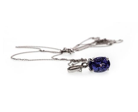 TANZANITE PENDANT, the oval tanzanite 7.5mm long, marked 14k to the bale, on a fine curb link chain marked 375 to the clasp, 
