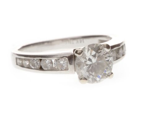 DIAMOND SOLITAIRE RING, the four claw mounted round brilliant cut diamond on channel set diamond shoulders, marked 14 K, size