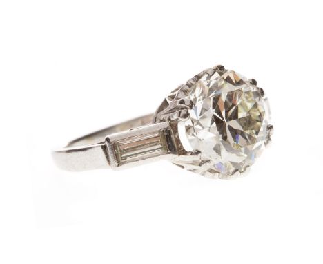 ART DECO DIAMOND SOLITAIRE RING, set with an old cut diamond of approximately 3.75 carats, flanked by two baguette cut stones