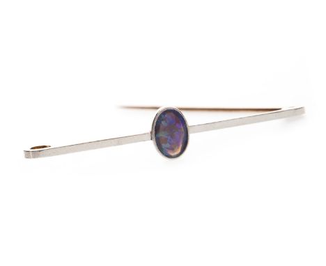 BLACK OPAL BAR BROOCH , the oval opal 8.5mm long, set to a bar marked 15ct and PLAT to the reverse, 51, long, 2.5g