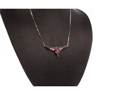DIAMOND AND RED GEM SET NECKLET, set with faceted oval red gems and round diamonds, with a red gem set drop, on chain marked 