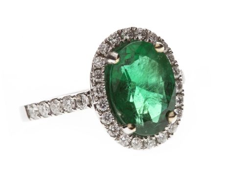 EMERALD AND DIAMOND CLUSTER RING, the impressive oval emerald approximately 3.04 carats, within a diamond halo, on diamond se