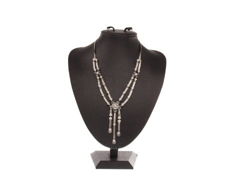 DIAMOND NECKLET, formed by a central floral motif with three suspended oval drops and flanked by further smaller floral motif
