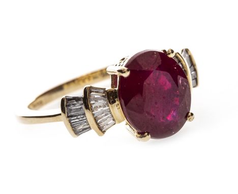 RUBY AND DIAMOND RING, the ruby of approximately 2.30 carats and flanked by two sections set with baguette cut diamonds, in n