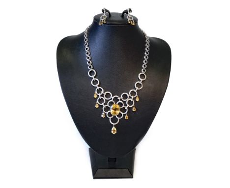 YELLOW TOPAZ AND DIAMOND NECKLET, formed by an openwork diamond set section with central oval topaz 19mm long, with suspended