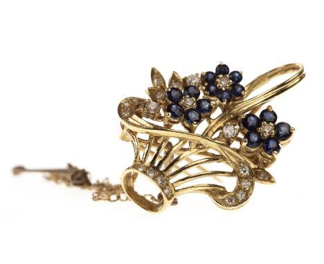 DIAMOND AND BLUE GEM SET BASKET BROOCH PENDANT, the basket set with round diamonds and modelled with three flowers, each form