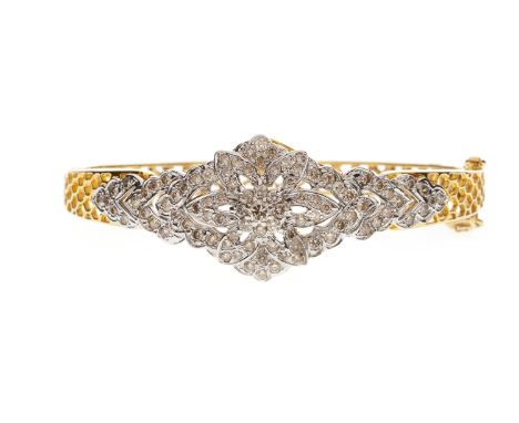 DIAMOND SET BANGLE, of oval form, with a central decorative pierced diamond set section, the body of the bangle formed by pie