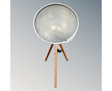 A contemporary halogen style lamp on tripod stand.
