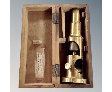A vintage brass field microscope in fitted box.