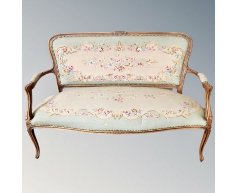A three-piece French beech framed salon suite upholstered in tapestry fabric.