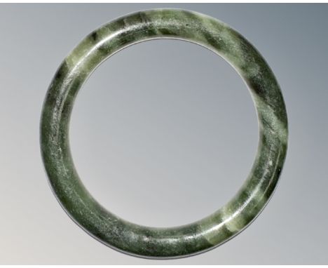 A carved jade circular bangle, inner diameter 58mm.