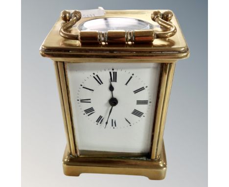 A brass cased carriage clock with key.
