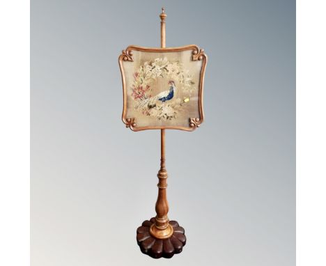 A 19th century mahogany and beech tapestry pole screen.