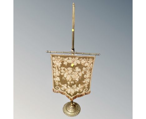 An antique brass and tapestry table pole screen.