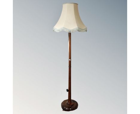 A 20th century beech wood standard lamp with shade.
