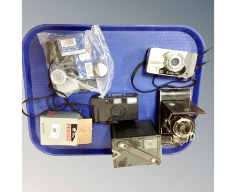 A collection of vintage cameras including a Kodak Brownie Model C and an Olympus Superzoom 160, together with a Pentax AF 160