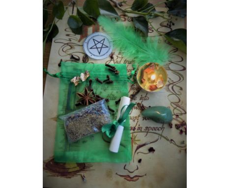 A ritual magic spell kit containing handmade votive, pentagram, incense, feather, quartz crystal etc 