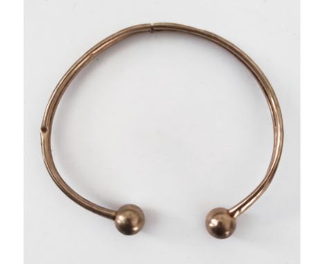 A 9ct gold bangle weighing 4 grams.