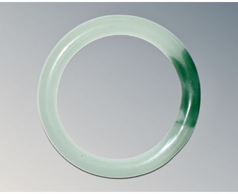 A carved jade circular bangle, inner diameter 58mm.