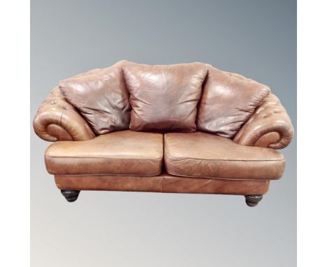 A Chesterfield style two seater settee in brown buttoned leather 