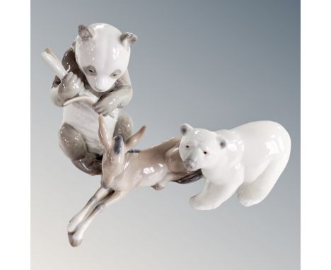 A Lladro figure of a polar bear together with a further Lladro donkey and a Nao panda with bamboo.