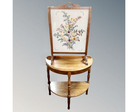 A 20th century oak framed tapestry fire screen together with an oak D-shaped hall table.