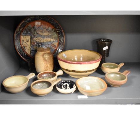 An assorted collection of studio pottery, to include an Oriental inspired plate with pagoda design on terracotta coloured gro