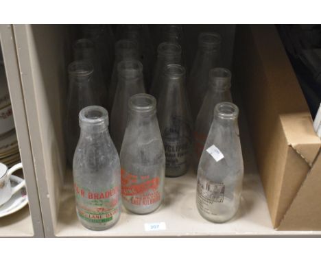 A collection of vintage glass milk bottles with adverts, of Kilbride, Longridge, Knottend interest etc.