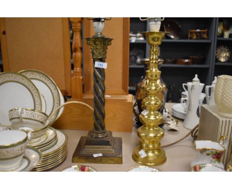 A brass Corinthian column form table lamp, with spiralled/ twisted stem and stepped bases, sold with a similar lamp.