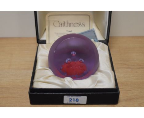 A Caithness glass paperweight in case. 'Triad' designed by Colin Terris.
