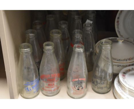 A collection of vintage advertising milk bottles, including Darwen, Abbeytown and Lindale interest.