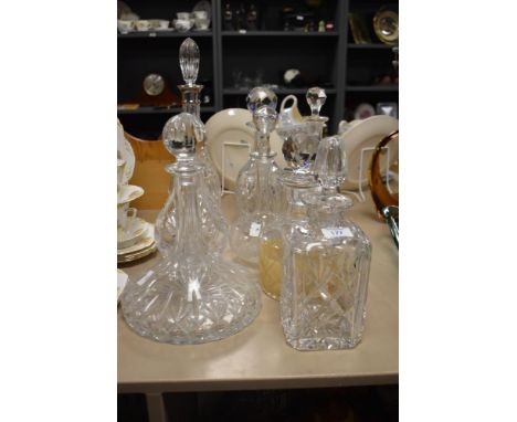 A selection of vintage decanters, including cut glass and etched examples.